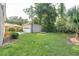 Expansive backyard with a detached garage surrounded by green grass and mature trees at 126 Cleland St., Georgetown, SC 29440