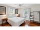 Bedroom with hardwood floors, featuring a bright interior with a large window and a ceiling fan at 126 Cleland St., Georgetown, SC 29440