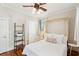 Bright bedroom with a queen-size bed, wood floors, and a modern shelving unit, perfect for storage at 126 Cleland St., Georgetown, SC 29440