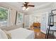 Bedroom featuring wood floors, an adjacent living room with french doors, and natural light from large windows at 126 Cleland St., Georgetown, SC 29440