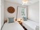 Cozy bedroom featuring two twin beds with white bedding and a decorative woven wall hanging at 126 Cleland St., Georgetown, SC 29440