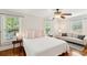 Bright bedroom with hardwood floors, three windows, and a cozy sitting area at 126 Cleland St., Georgetown, SC 29440