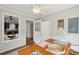 Cozy dining area with wood floors, ceiling fan, and a glimpse into the kitchen through the mirror at 126 Cleland St., Georgetown, SC 29440