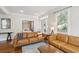 Bright living room with hardwood floors, neutral paint, large window, and comfortable leather seating at 126 Cleland St., Georgetown, SC 29440