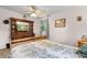 Comfortable bedroom with a patterned bedspread, window with curtains, and a wooden dresser at 1272 Park Hill Dr., Conway, SC 29526