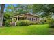 Charming brick home featuring a cozy front porch and a well-manicured lawn, surrounded by lush greenery at 1272 Park Hill Dr., Conway, SC 29526