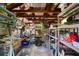 A cluttered garage with exposed beams, shelving, tools, and various stored items at 1272 Park Hill Dr., Conway, SC 29526