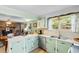 Charming kitchen with green cabinets and stainless steel appliances, blending vintage aesthetics with functional design at 1272 Park Hill Dr., Conway, SC 29526