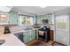 Bright kitchen features fresh green cabinets, stainless appliances, an outside view and vintage accents at 1272 Park Hill Dr., Conway, SC 29526