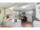 Cozy kitchen featuring green cabinets, stainless steel appliances, and a vintage aesthetic with an adjacent door to the outside at 1272 Park Hill Dr., Conway, SC 29526