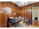 Office space featuring wood paneling, a rolling chair, desk and an exterior door at 1272 Park Hill Dr., Conway, SC 29526