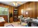 Wood paneled office space with a desk, rolling chair, and ample shelving at 1272 Park Hill Dr., Conway, SC 29526