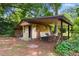 Charming outbuilding with brickwork, open porch, and seating area nestled in a leafy yard at 1272 Park Hill Dr., Conway, SC 29526