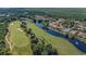 Aerial view of the neighborhood showcasing waterfront homes on a golf course community at 1503 Cadiz Dr., Myrtle Beach, SC 29579