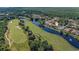 Beautiful aerial view of a home on a golf course with waterfront access and lush landscaping at 1503 Cadiz Dr., Myrtle Beach, SC 29579