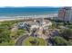 An aerial view showcasing an oceanfront resort with pools and beautifully landscaped grounds at 1503 Cadiz Dr., Myrtle Beach, SC 29579