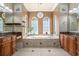 A luxurious bathroom featuring a large soaking tub, tiled flooring, and dual sink vanities at 1503 Cadiz Dr., Myrtle Beach, SC 29579