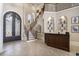 Grand foyer with a wrought iron staircase, a bar area, and tile flooring at 1503 Cadiz Dr., Myrtle Beach, SC 29579