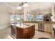 A gourmet kitchen featuring granite counters, center island, stainless steel appliances, and ample windows at 1503 Cadiz Dr., Myrtle Beach, SC 29579