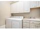 Laundry room featuring white cabinets, a washer, a dryer and a sink at 1503 Cadiz Dr., Myrtle Beach, SC 29579
