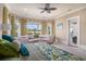 A large main bedroom is showcased by lots of windows, a ceiling fan and an attached sitting area at 1503 Cadiz Dr., Myrtle Beach, SC 29579