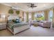 A large main bedroom is showcased by lots of windows, a ceiling fan and an attached sitting area at 1503 Cadiz Dr., Myrtle Beach, SC 29579