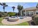 Backyard pool area with a water feature, palm trees, and a covered patio space at 1503 Cadiz Dr., Myrtle Beach, SC 29579