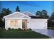 Charming one-story home featuring a brick facade, a two-car garage, and meticulously landscaped front yard at 1545 Regal Fern Way, Longs, SC 29568