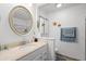 Well-lit bathroom featuring a vanity with a sink, decorative mirror, and charming starfish decorations at 1546 Bay Tree Ln., Myrtle Beach, SC 29575