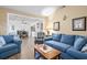 Cozy living room with comfortable blue sofas and a glimpse into the dining area, creating an inviting space at 1546 Bay Tree Ln., Myrtle Beach, SC 29575