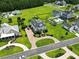 An aerial view of an estate-style home with a circular driveway, mature trees, and well-manicured landscaping at 157 Pottery Landing Dr., Conway, SC 29526