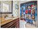 Whimsical bathroom featuring playful Star Wars themed shower curtain and green polka dot accent wall at 157 Pottery Landing Dr., Conway, SC 29526