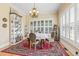 Bright dining area with a round table, chandelier, and large window with plantation shutters at 157 Pottery Landing Dr., Conway, SC 29526