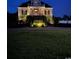 Night shot of home showing manicured lawn, landscape lighting, and front of home at 157 Pottery Landing Dr., Conway, SC 29526
