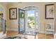 Inviting foyer with hardwood floors, decorative rugs, elegant lighting, and a glimpse of the outdoor greenery at 157 Pottery Landing Dr., Conway, SC 29526