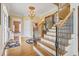 Grand foyer featuring hardwood floors, ornate staircase with iron railings, chandelier, and neutral color palette at 157 Pottery Landing Dr., Conway, SC 29526
