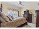 Elegant main bedroom features a four poster bed, large window and wooden dresser with TV at 157 Pottery Landing Dr., Conway, SC 29526