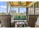 Relaxing screened porch features comfortable seating and views of the surrounding neighborhood at 157 Pottery Landing Dr., Conway, SC 29526