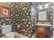 Stylish powder room featuring floral wallpaper, framed mirror, and vanity with sink at 157 Pottery Landing Dr., Conway, SC 29526