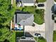 Aerial view of the home with a back patio, mature trees, well-kept lawn, and spacious driveway at 1575 Victoria Ln., Myrtle Beach, SC 29577