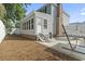 Back of home featuring a sunroom, patio, and access to a charming backyard space with a hammock at 1575 Victoria Ln., Myrtle Beach, SC 29577