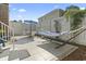 Cozy backyard patio with a hammock, table, chairs, and white fence, perfect for relaxation at 1575 Victoria Ln., Myrtle Beach, SC 29577