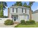 Charming two-story home featuring a well-manicured lawn, an American flag, and a welcoming front entrance at 1575 Victoria Ln., Myrtle Beach, SC 29577