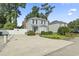 Two-story home featuring blue siding, a landscaped front yard, and an extended driveway at 1575 Victoria Ln., Myrtle Beach, SC 29577