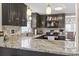 This kitchen boasts stylish granite countertops, dark cabinetry, and modern stainless steel appliances at 1575 Victoria Ln., Myrtle Beach, SC 29577