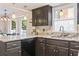 Close-up of the kitchen with dark cabinets, marble countertops, and pendant lighting at 1575 Victoria Ln., Myrtle Beach, SC 29577