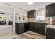 Well-lit kitchen with dark cabinets, marble countertops, and modern appliances with an open concept design at 1575 Victoria Ln., Myrtle Beach, SC 29577