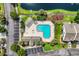 Overhead aerial of a community pool with parking, landscaping, and nearby condo buildings at 158 Palisade Loop # 158, Pawleys Island, SC 29585