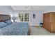 Bright bedroom with a comfortable queen-sized bed, wooden furniture, and a sunlit window at 158 Palisade Loop # 158, Pawleys Island, SC 29585