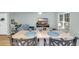 Open dining area with a large table, seating for four, and a view of the living room and a large flat screen TV at 158 Palisade Loop # 158, Pawleys Island, SC 29585